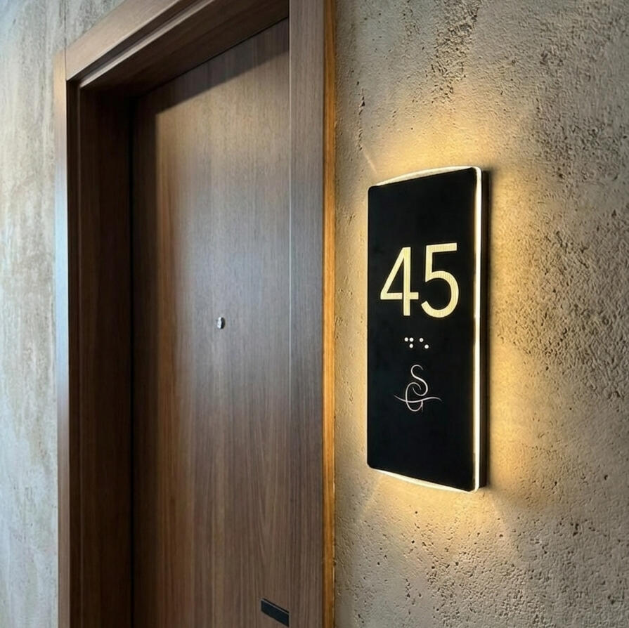 ADA compliant Braille hotel room number sign mounted on a modern hotel door Hotel door number plaque with ADA compliant Braille and brand logo